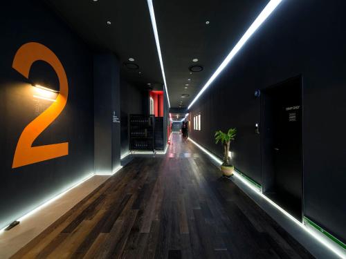 a hallway of a building with wooden floors and lights at Hotel Park Habio in Seoul