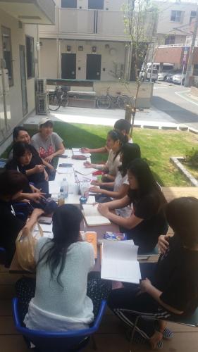 a group of people sitting around a long table at Tokyo Guest House 2020 in Tokyo