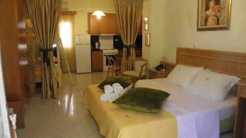 a bedroom with a large bed with towels on it at Irida Beach Resort Suites in Kyparissia