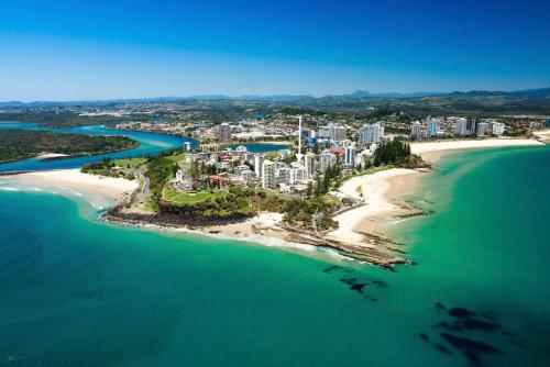 an aerial view of a beach with a city at The Garland at Rainbow Bay in Gold Coast
