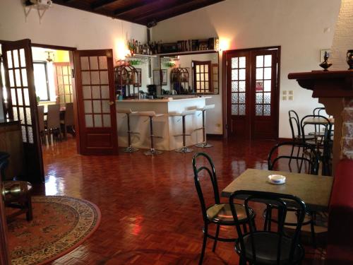 a room with a bar and some tables and chairs at Domestival in Vila Verde dos Francos