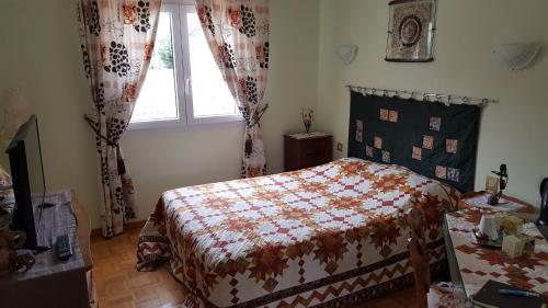 a bedroom with a bed and a window at Castel Parc in Périgny