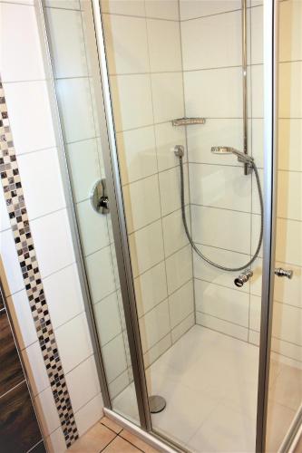 a shower with a glass door in a bathroom at Beilsteiner Gästehaus in Beilstein