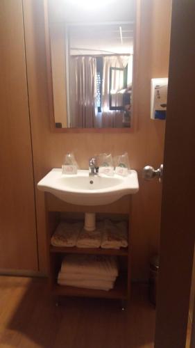 a bathroom with a sink and a mirror at Hostal Bonaterra in Maçanet de la Selva