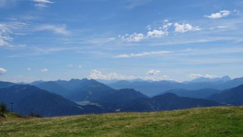 a view of the mountains from a grassy hill at Ferienhaus Enzi in Weissbriach