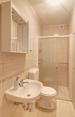 a bathroom with a sink and a toilet and a shower at Marija Rooms in Dubrovnik