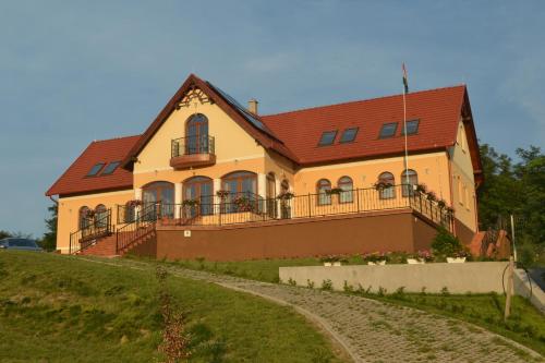 a large house on top of a hill at Berezdtető Vendégház in Cserépfalu