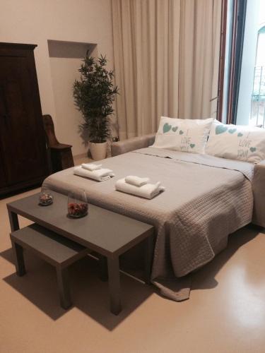 a bedroom with a bed and a table with towels on it at Venetian House in Venice