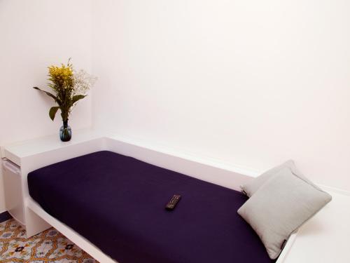 a room with a bed with a remote control at Antonio Massa Lubrense in Massa Lubrense