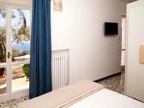 a bedroom with a bed and a window at Antonio Massa Lubrense in Massa Lubrense