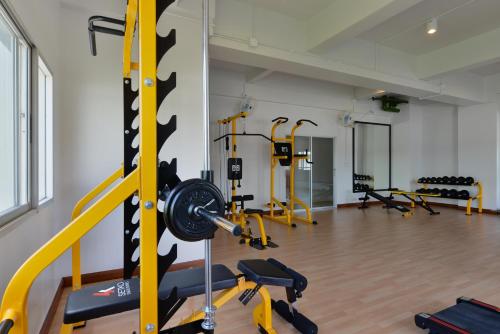 a gym with yellow and black treadmills at Ruenthip Pattaya in Pattaya North