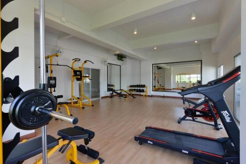 a gym with several exercise equipment in a room at Ruenthip Pattaya in Pattaya North