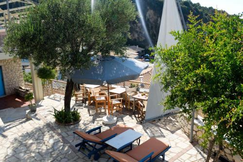 an overhead view of a patio with a table and umbrella at Arenaria Leucadia in Agios Nikitas
