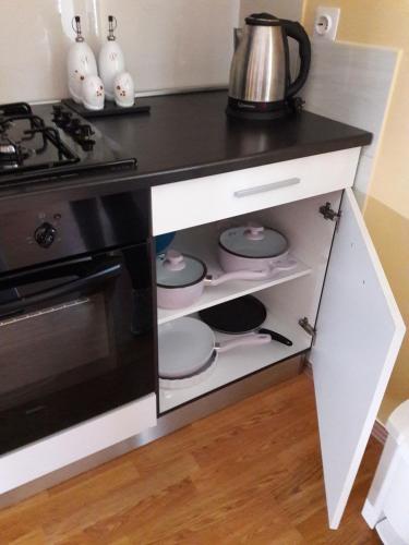 a kitchen with a black and white counter and a stove at Apartments Korana, BelajskePoljice in Duga Resa