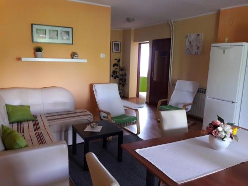 a living room with white furniture and a white refrigerator at Apartments Korana, BelajskePoljice in Duga Resa