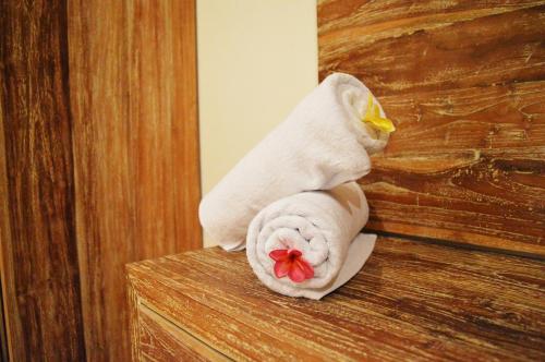 a white towel sitting on top of a door at Tirtha Canggu Suites in Canggu
