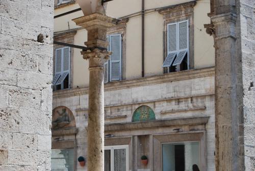 a building with a column in front of it at A Casa di Lola in Ascoli Piceno