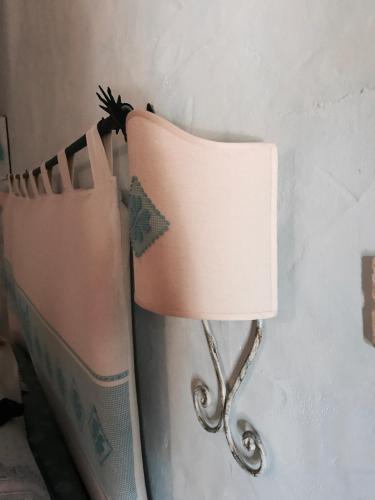 a pink lamp hanging on a clothes line at Il Nuraghe del lago Coghinas in Oschiri