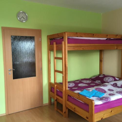 a bedroom with two bunk beds and a door at Apartmány Racek in Ostružná