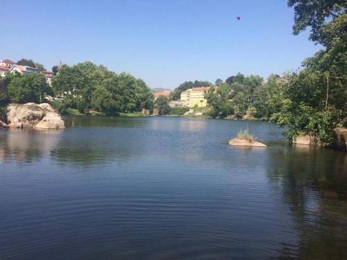a river with a small island in the middle at Vila Teixeira in Amarante