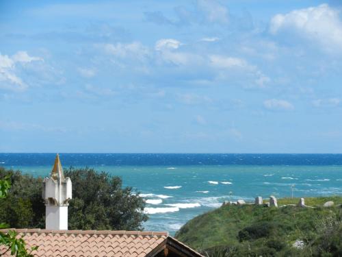 a view of the ocean with a white lighthouse at Tenuta Molino di Mare- Ecoresort in Rodi Garganico