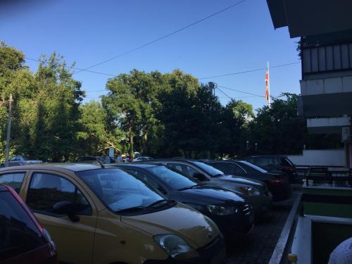 a row of cars parked in a parking lot at Apartments Villa Zora in Star Dojran