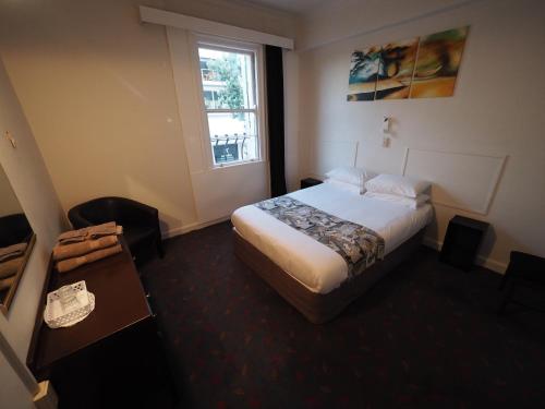 a hotel room with a bed and a window at Whakatane Hotel in Whakatane