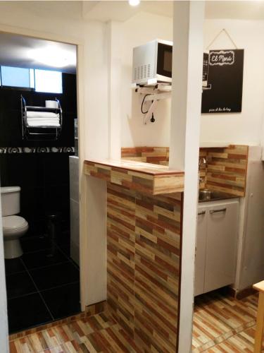 a kitchen with a counter with a microwave at White Hope Apartment in Lima