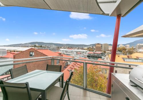 a balcony with a table and chairs and a view at Sullivans Cove Apartments in Hobart