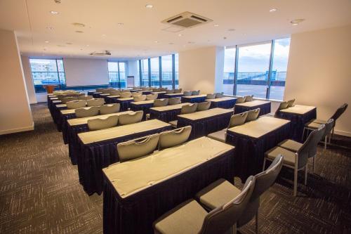 a large room with chairs and tables and windows at IBIS Styles Ulaanbaatar Polaris in Ulaanbaatar