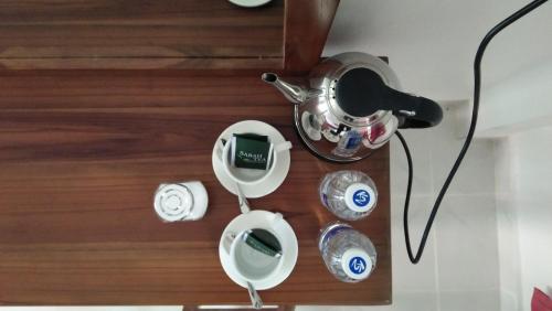 a close up of a table with plates and a blender at Skyville Zen Resort,Kundasang in Kundasang