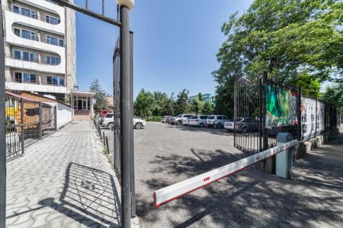 a fence on the side of a street at Hotel Osh-Nuru in Osh