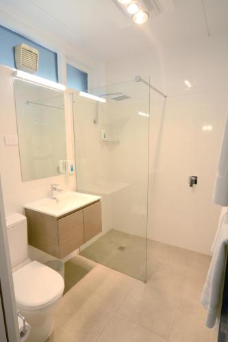 a bathroom with a toilet and a sink and a shower at Bridge Hotel in Smithton