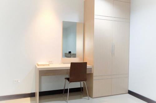 a bathroom with a vanity with a mirror and a chair at Memory Place Samphran in Sam Phran
