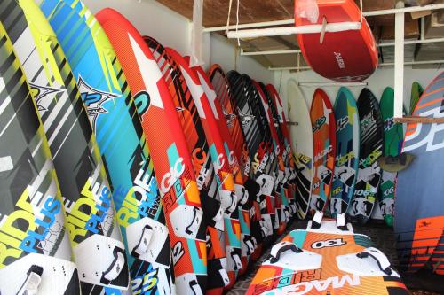 a bunch of surfboards are lined up on a wall at Surf4You Residence in Mui Ne