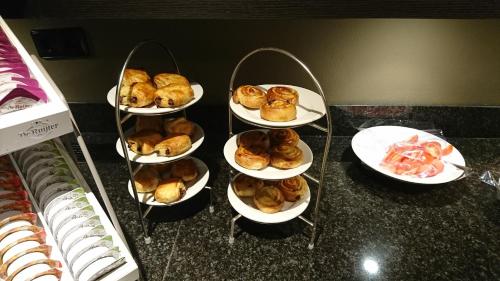 a group of plates of pastries on a counter at Fletcher Hotel-Restaurant Het Witte Huis in Amersfoort