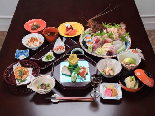 a table topped with dishes of food on a table at Hotel Hagoromo in Shizuoka