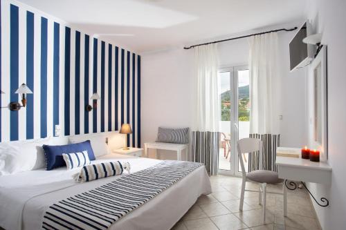 a bedroom with a bed and a dresser at Iris Beach Hotel in Monemvasia