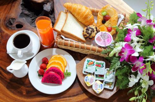 a table with a tray of breakfast foods and a cup of coffee at Maharaja Villas Bali - CHSE Certified in Kerobokan