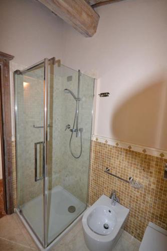 a bathroom with a shower and a toilet and a sink at Casalta Di Pesa in Siena