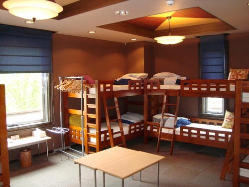 a room with four bunk beds in a room at Kashimayari Sports Village in Omachi