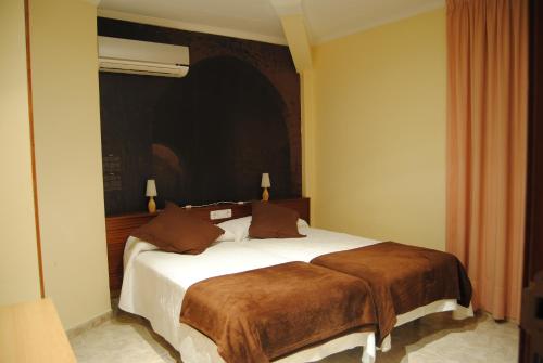 a bedroom with a large bed with a brown blanket at Guilleumes Montserrat in Monistrol