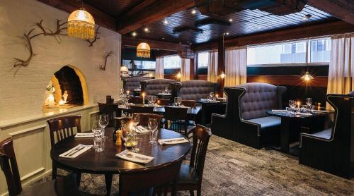 a restaurant with tables and chairs and a fireplace at Original Sokos Hotel Vaakuna Rovaniemi in Rovaniemi