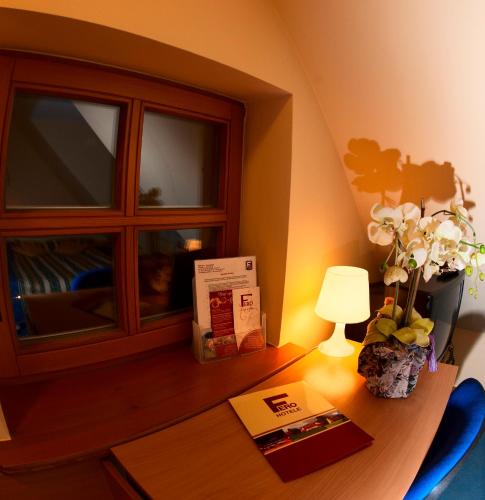 a desk with a window and a lamp on it at Hotel Fero Lux in Korbielów