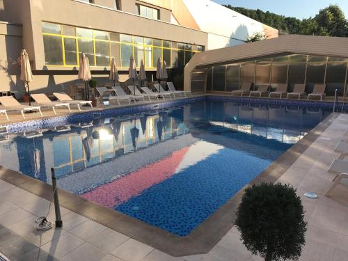 a swimming pool in front of a hotel at Boutique Hotel VSK Kentavar in Dryanovo