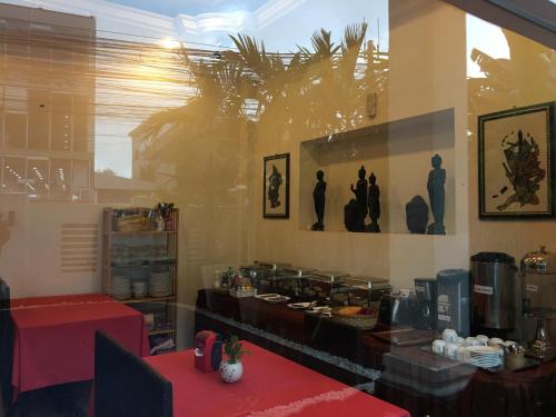 a dining room with a table and a counter with food at King Boutique Hotel in Siem Reap