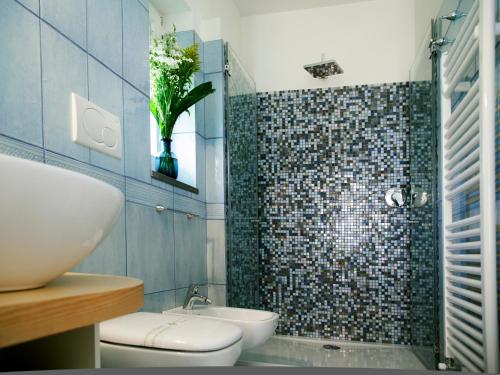 a bathroom with a shower and a toilet and a sink at Antonio Massa Lubrense in Massa Lubrense