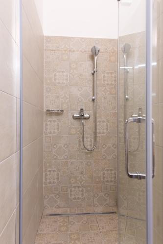 a bathroom with a shower with a glass door at Villa Belsito in Lovran
