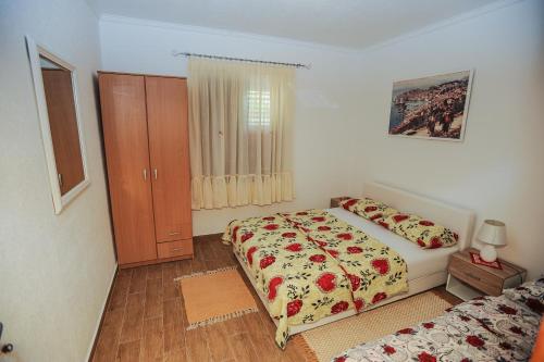 a bedroom with a bed and a dresser at Apartments Phoenix in Ivanica