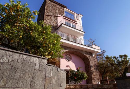 a tall building with a balcony on top of a wall at Antonio Massa Lubrense in Massa Lubrense
